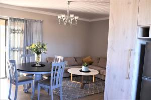 a living room with a table and a couch at Hidden Gem in Bloemfontein