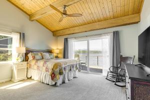a bedroom with a bed and a ceiling fan at Bayfront Home with Private Beach in Poulsbo! in Poulsbo