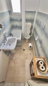 a bathroom with a sink and a toilet at Central Comfort Guesthouse in Larisa