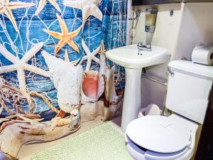 a bathroom with a toilet and a sink at Cande's Apartments in Isla Mujeres +67 photos