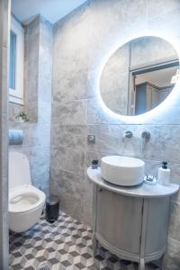 a bathroom with a sink and a mirror at To Spitaki in Thessaloniki