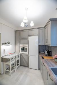a kitchen with a white refrigerator and a table at To Spitaki in Thessaloniki +18 photos