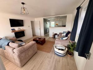 a living room with two couches and a tv at Number 10 in Walcott