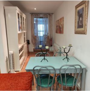 a dining room with a blue table and chairs at El Arco de la Malena 2 in Siles
