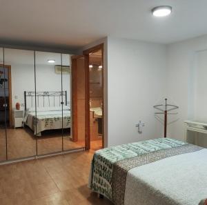 a bedroom with a bed and a glass wall at El Arco de la Malena 2 in Siles