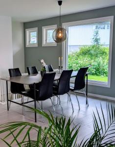 a dining room with a table and chairs at Fjellhagen - Geirangerfjord view in Hellesylt