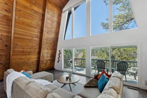 a living room with a couch and a table at Quiet Mountain Cabin in Lake Arrowhead