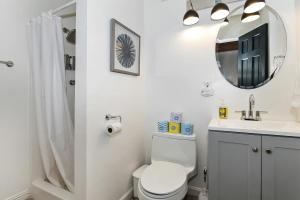 a bathroom with a toilet and a sink and a mirror at Quiet Mountain Cabin in Lake Arrowhead +39 photos