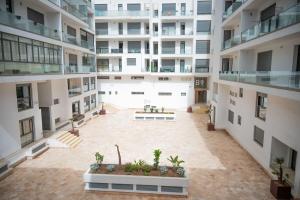 アガディールにあるPrime 2BR Agadir Apt with Pool, Near Beach and Cafésの大きなアパートメントビル内の空中の中庭