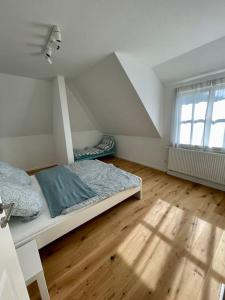 a room with two beds and a window in it at Ferienhaus Butjadingen - Haus Ruhwarden in Ruhwarden