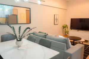 een woonkamer met een bank en een tafel bij Alea Residences in Manilla