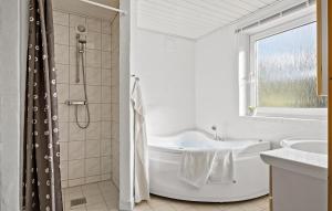 a white bathroom with a tub and a shower at Cozy Home In Fjerritslev With Wifi in Fjerritslev +21 photos