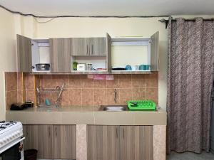 a kitchen with a sink and a counter top at Emerald in Ruaka