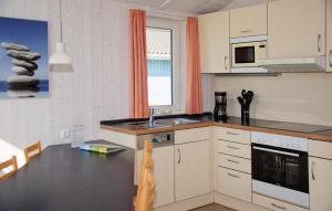 a kitchen with a sink and a counter top at Friedrichskoog-Deichblick 6 in Friedrichskoog