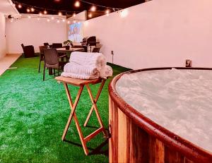 a room with a bath tub and green carpet at Ocean Front Apartments in Arecibo