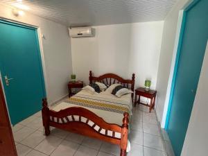 a bedroom with a bed with two night stands and two lamps at LA DESIOR in Saint-Louis