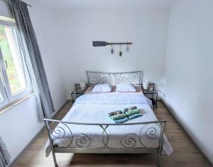 a bedroom with a bed with two pillows on it at Apartment Sea Garden in Ičići