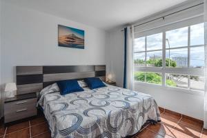 une chambre avec un lit et une grande fenêtre dans l'établissement Beautiful Duplex in Callao Salvaje, à Callao Salvaje 32 autres photos