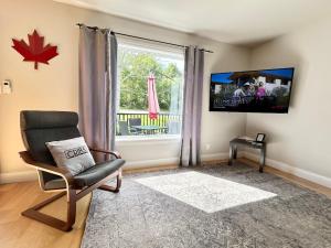 a living room with a chair and a window at Cribs on the Hill in Picton