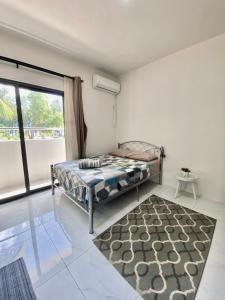 a bedroom with a bed and a large window at Sunset Views 3-Bedroom Apt, 1min Walk to Beach - NYHA1 in Flic-en-Flac +34 photos