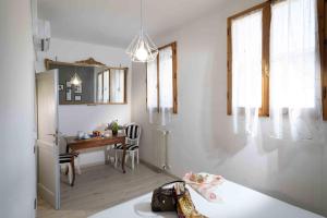 a kitchen and dining room with a table and a desk at Lezioso, Apartments in Florence in Florence