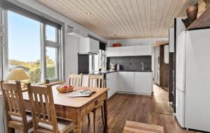 a kitchen and dining room with a table and chairs at 2 Bedroom Lovely Home In Thisted in Thisted