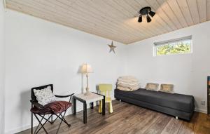 a room with a bed and a table and chairs at 2 Bedroom Lovely Home In Thisted in Thisted