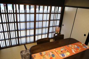 a room with a table and chairs and a cell phone at Show-an Machiya Inn in Kyoto