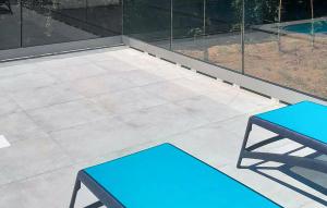 two blue benches sitting on top of a patio at Lovely Home In Lovrin in Heki