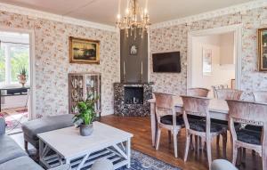 a living room with a table and chairs at Nice Apartment In Landeryd With Wifi in Långaryd