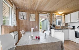 a kitchen and dining room with a table and chairs at Beautiful Home In Hejls With Sauna in Hejls