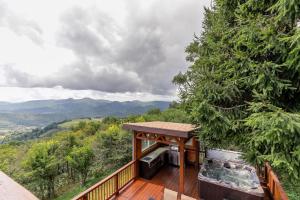 a deck with a view of the mountains at Grandview Haven in Banner Elk