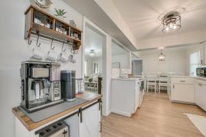 a large kitchen with white cabinets and a counter top at Gaylord Family Home Walk to Shops and Restaurants! in Gaylord