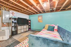 a living room with a couch and a tv at Gaylord Family Home Walk to Shops and Restaurants! in Gaylord