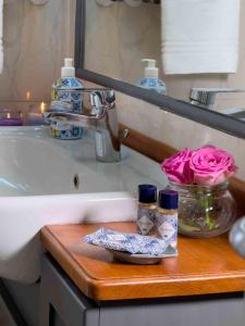 a bathroom counter with a sink and a wooden cutting board at Lezioso, Apartments in Florence in Florence +40 photos