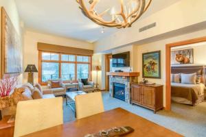 a large living room with a bed and a fireplace at Capitol Peak Lodge 3217 by Snowmass Mountain Lodging in Snowmass