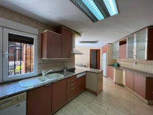 a large kitchen with a sink and a window at Hello Madrid in Madrid