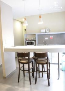 a kitchen with a large white table and chairs at ALOJAMIENTO CENTENARIO in Corrientes +33 photos