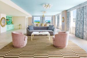 a living room with a couch and two chairs at The Goodtime Hotel, Miami Beach a Tribute Portfolio Hotel in Miami Beach