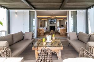 a living room with a couch and a table at Villa Maya Bali Inspired Villa in Mijas