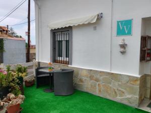 a patio with green grass next to a building at Casa Elvi in Gijón
