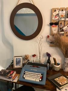 a desk with a keyboard and a mirror on a wall at Casa Velata a Spaccanapoli in Naples +68 photos