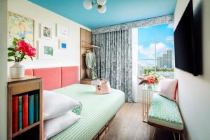 a small bedroom with a bed and a window at The Goodtime Hotel, Miami Beach a Tribute Portfolio Hotel in Miami Beach