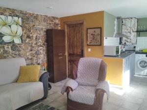 a living room with a couch and a chair at Casa Elvi in Gijón