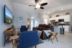 a living room with a couch and a table at New Build Pool Home With Modern Design and Open Floor Plan in Cape Coral in North Fort Myers