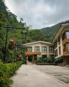 a building with a street light next to a mountain at Termales Santa Rosa De Cabal in Santa Rosa de Cabal