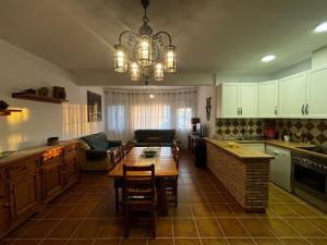 a kitchen with a table and a dining room at Casa Loarre in La Iruela