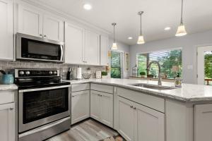 a kitchen with white cabinets and a sink at Piece of Heaven in New Braunfels