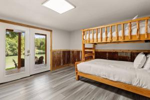 a bedroom with a bunk bed and a patio at Piece of Heaven in New Braunfels