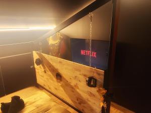 a room with a wooden box with a netflix sign at Love Room Luxure 50 Nuances in Jonzac